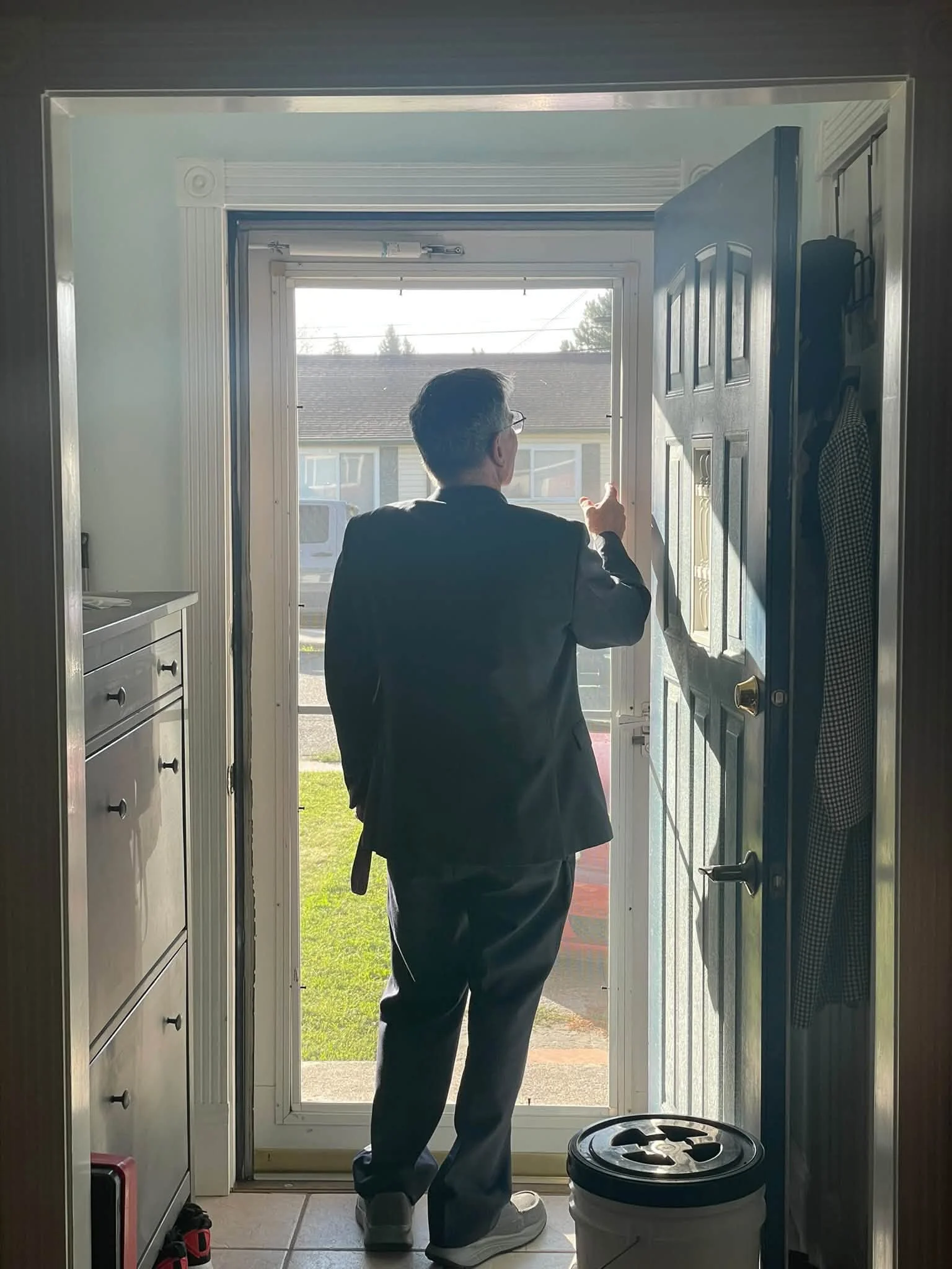 Tony in a Sunday suit inspecting the new screen door
